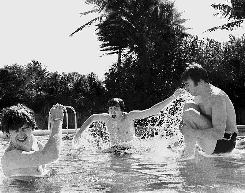 John Lennon cannonballs into the pool